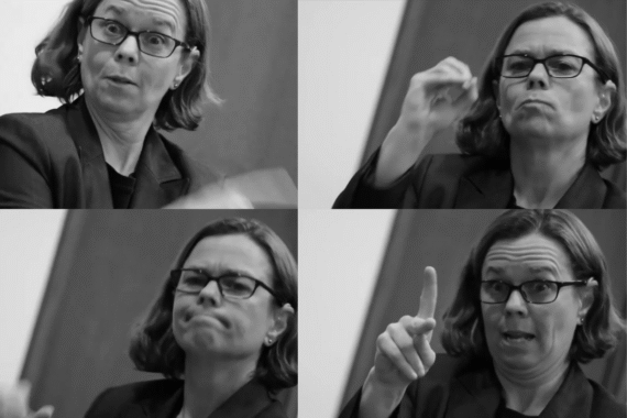 A black-and-white four-panel collage of a Deaf interpreter signing during a presentation. In two of the panels, the interpreter forms the ASL handshapes for “O” and “K,” showing clear facial grammar and expression. The images highlight the precision and visual detail involved in Deaf interpreting.