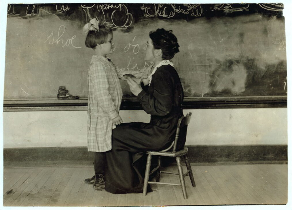 Teacher conducting speech training with a deaf child at the Oklahoma School for the Deaf in 1917.